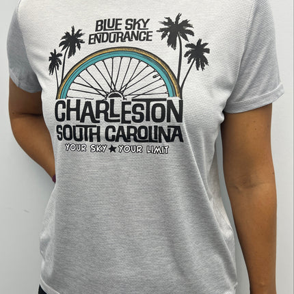Person wearing a gray t-shirt with a graphic design and text on a white background