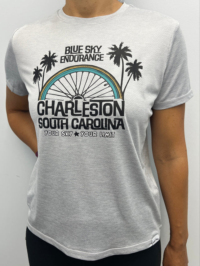 Person wearing a gray t-shirt with a graphic design and text on a white background