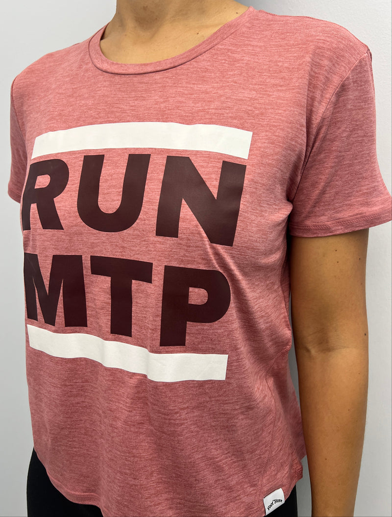 Person wearing a pink top with 'RUN MTP' text on a white background