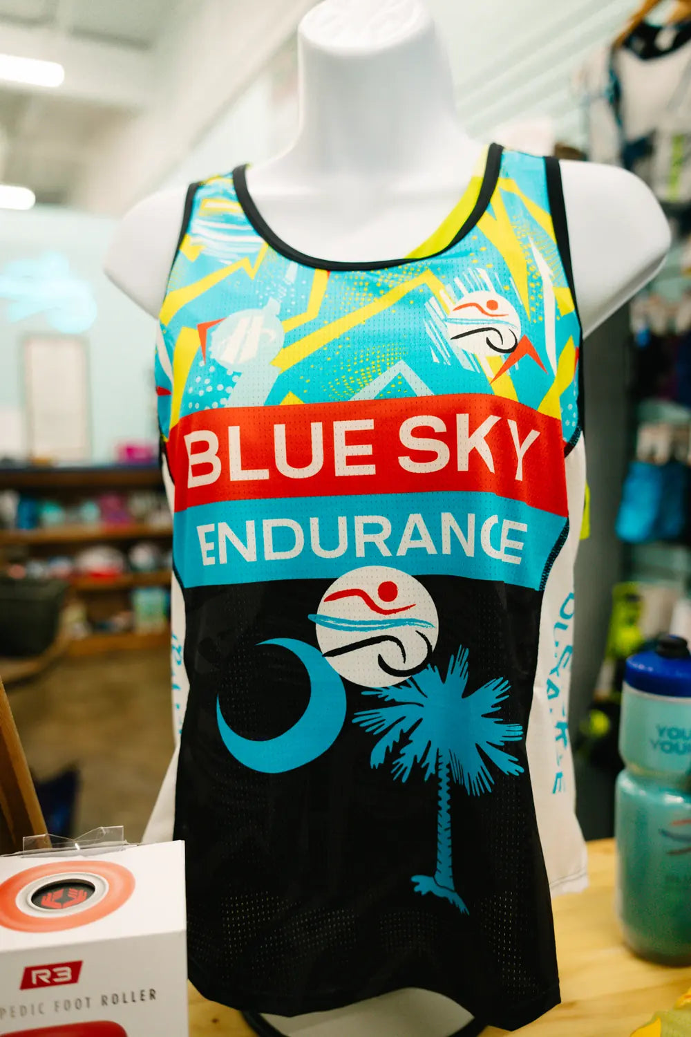 Blue Sky Endurance branded tank top with a palmetto tree and crescent moon design on a mannequin