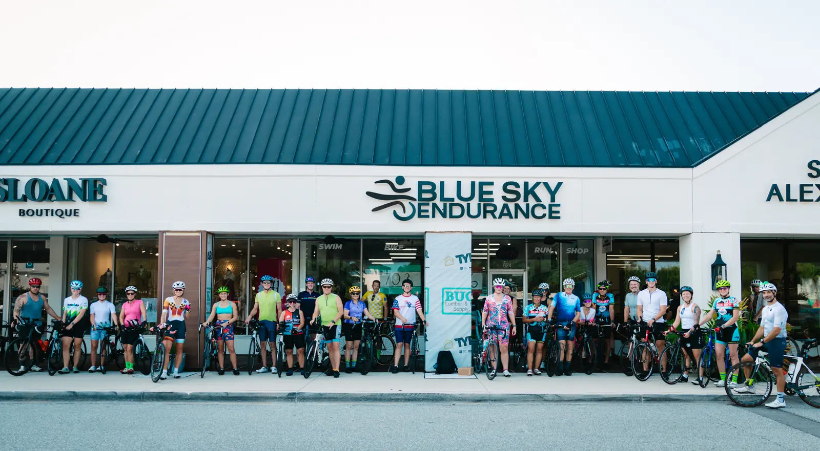 Cyclists lined up in front of the Blue Sky Endurance Coleman Blvd store before a group ride