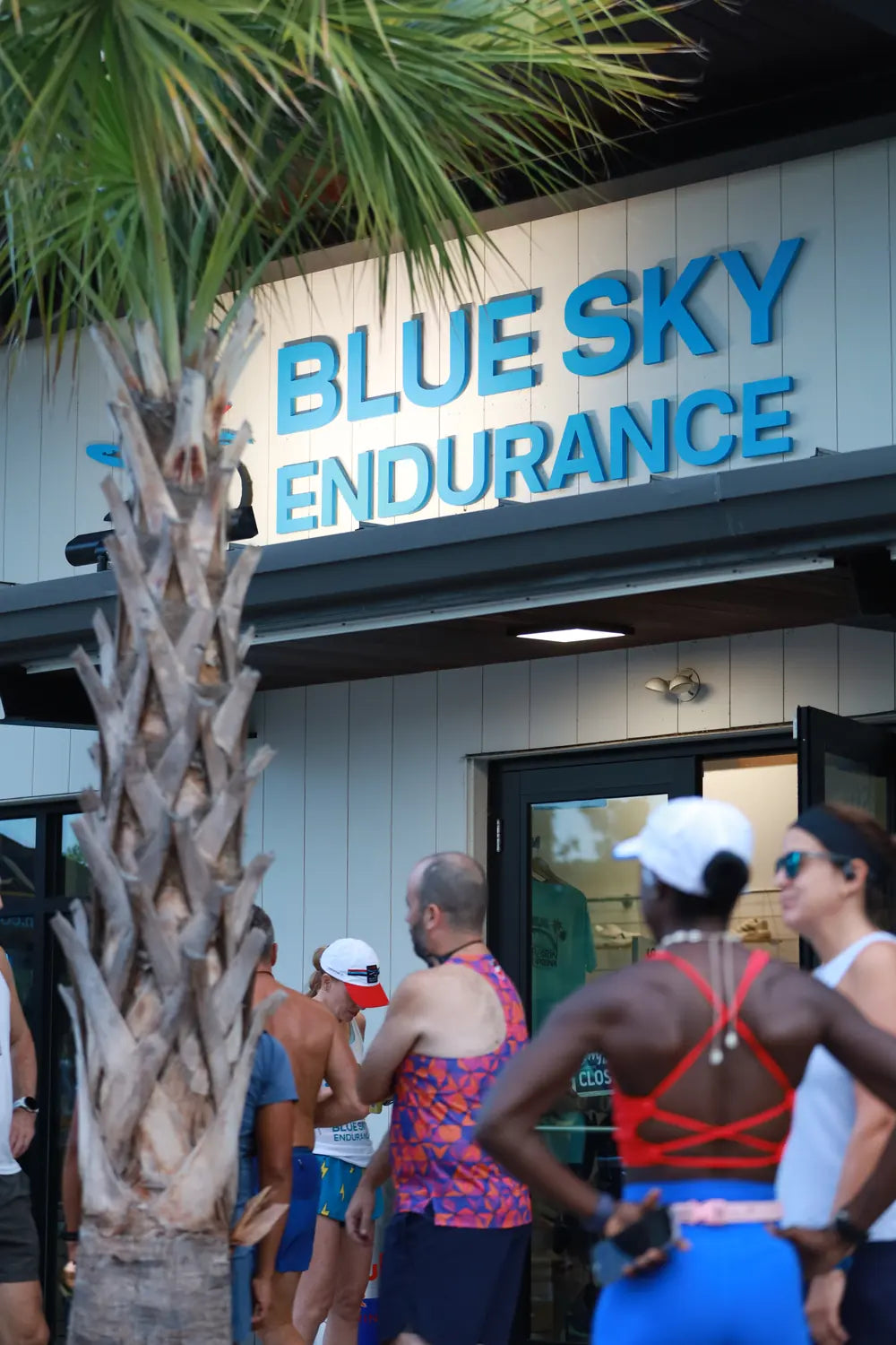 Runners gathering under the Blue Sky Endurance sign before a group run