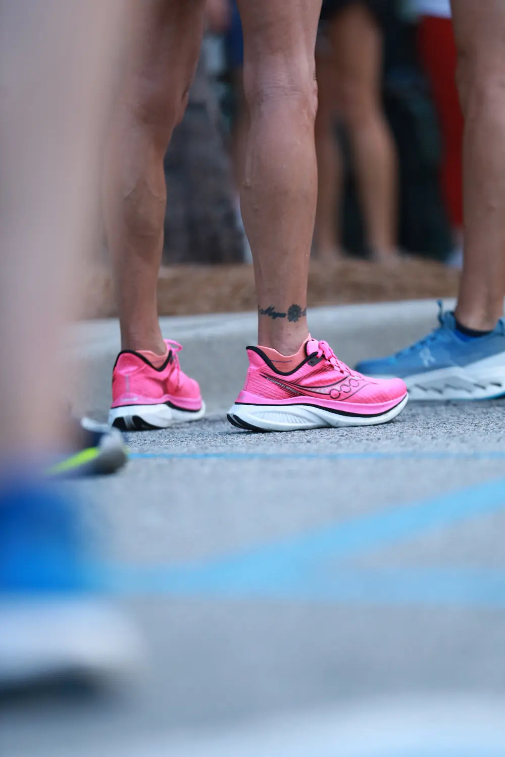 Close-up of runners’ shoes at the start of a group run