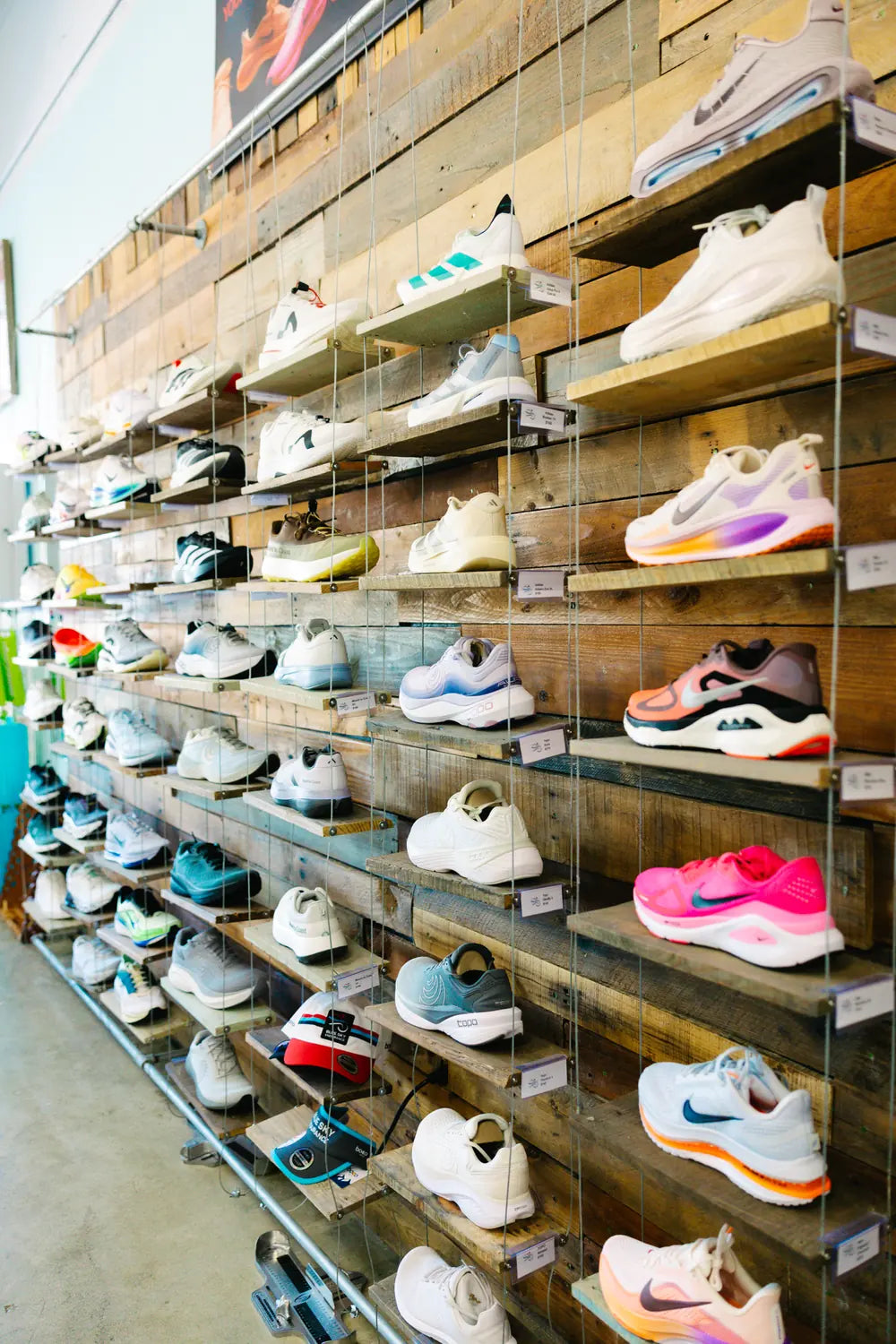 Running shoe wall stocked with road running shoes at Blue Sky Endurance in Mount Pleasant