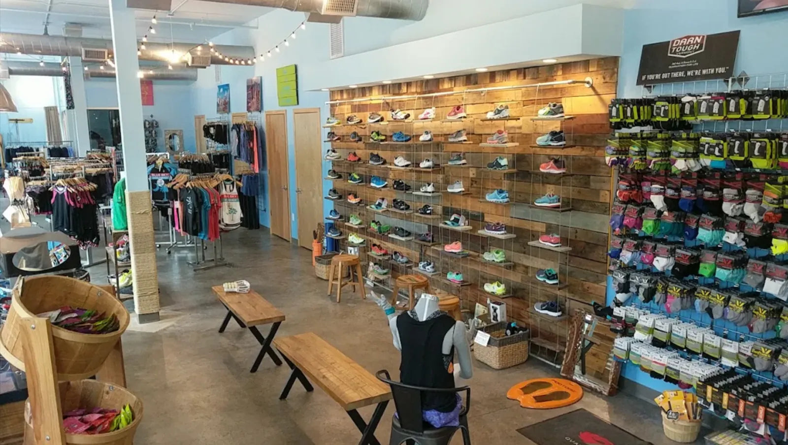 Running shoe wall and fitting benches inside the Blue Sky Endurance store in Mount Pleasant